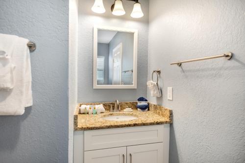 a bathroom with a sink and a mirror at Tropical Beach Resorts - Sarasota in Sarasota