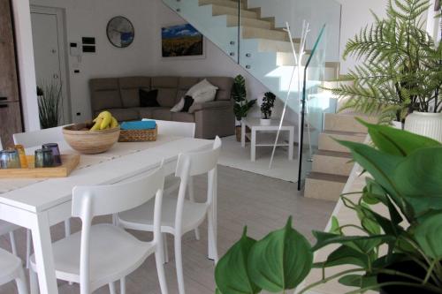 a living room with a white table and chairs at Magnolia in Francavilla al Mare