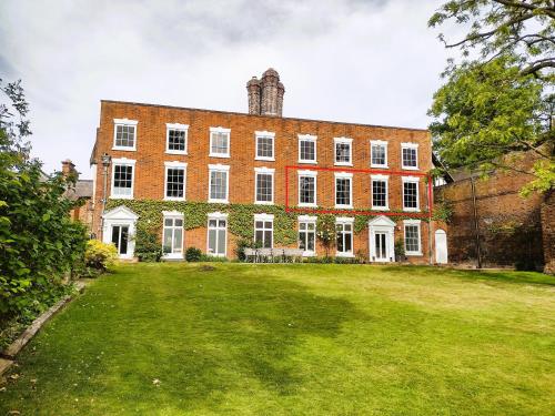 シュルーズベリーにあるThe Old House Apartmentの大きな庭のある大きなレンガ造りの建物