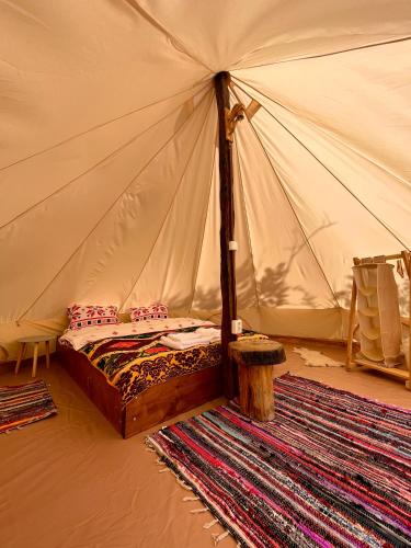 a bedroom with a bed in a tent at Wild Glamping Cornereva in Cornereva