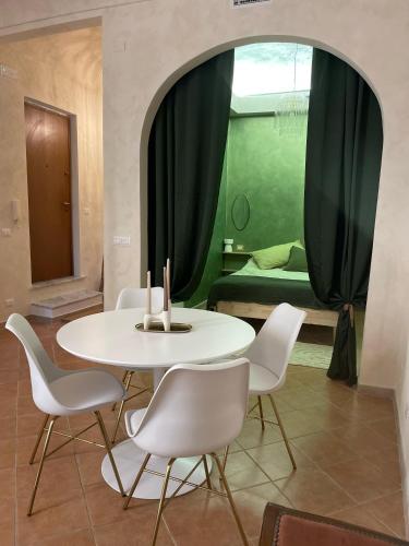 a table and chairs in a room with a bedroom at Antica in Savona