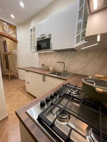 a kitchen with a stove top oven in a kitchen at Antica in Savona