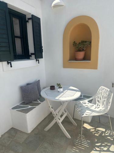 a table and chairs in a corner of a room at Eleni Dream Village in Parikia