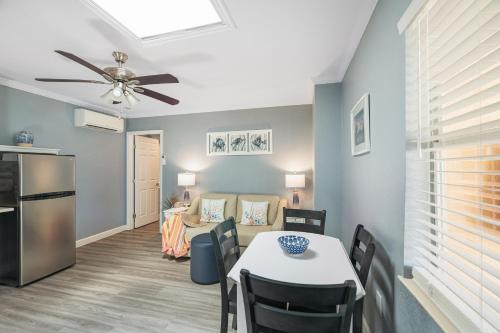 a living room with a dining table and a kitchen at Tropical Beach Resorts - Sarasota in Sarasota