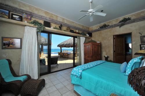 a bedroom with a bed and a view of the ocean at Rancho De Costa by Cabo Villas in La Paz