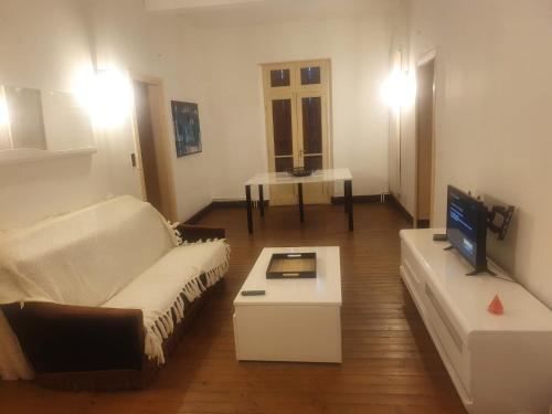 a living room with a couch and a tv at la roulotte dépote in Monbéqui