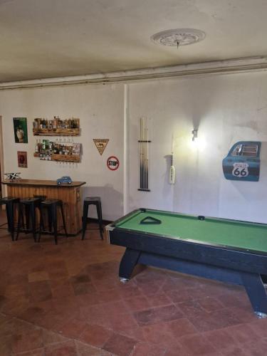 a room with a pool table and a bar at la roulotte dépote in Monbéqui