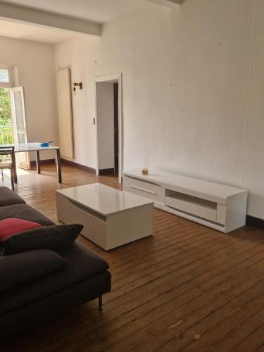 a living room with a couch and a coffee table at la roulotte dépote in Monbéqui