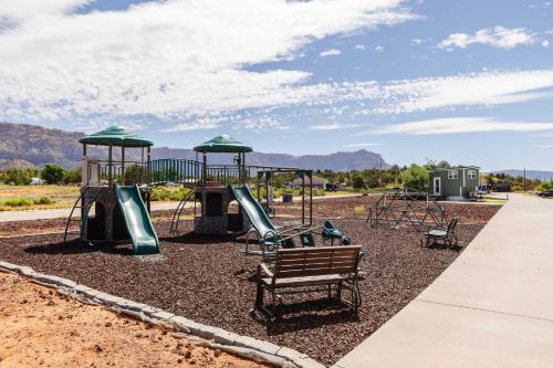 a playground with a slide and a swing set at Aloha Tiny Home in Apple Valley