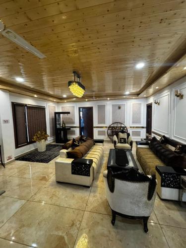 a large living room with couches and chairs at The Ivyview Villa Kumarhatti Barog Near Kasauli in Barog