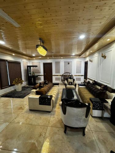 a large living room with couches and chairs in it at The Ivyview Villa Kumarhatti Barog Near Kasauli in Barog