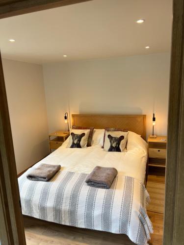 a bedroom with a bed with two cats on it at Chalet Tomsine in Samoëns