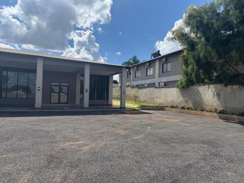 an empty parking lot in front of a building at Milford Lodge in Kitwe