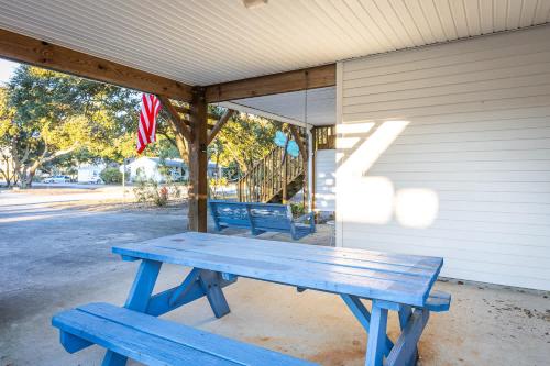 a blue picnic bench sitting outside of a house at 5 Min Walk to Nags Head Beach and Centrally Located in Nags Head