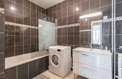 une salle de bain avec une machine à laver et un lavabo dans l'établissement Majestic Luxueux 2 big Bedroom Eiffel-Tower, à Paris