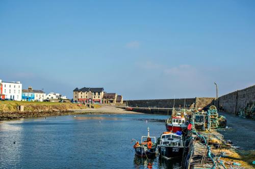 a group of boats docked in a body of water at Pier Head Hotel Spa & Leisure in Mullaghmore