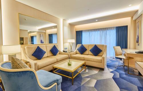 a living room with a couch and a table at The Diplomat Radisson Blu Hotel Residence & Spa in Manama