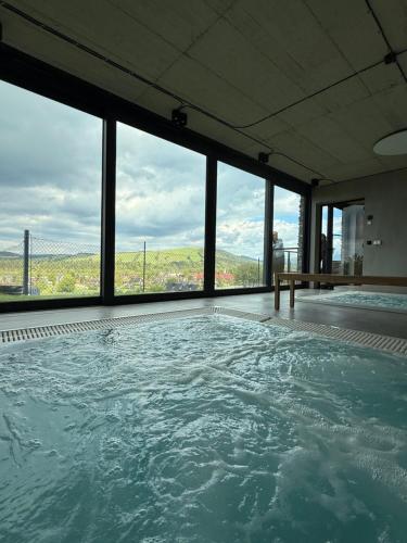 a large swimming pool with a view of the ocean at TatryTop Słoneczna Rezydencja Jacuzzi & Sauna in Białka Tatrzanska