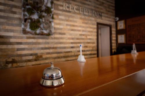 a tea kettle with a candle on a table at Snezhanka Hotel Pamporovo-All inclusive & Half Board in Pamporovo