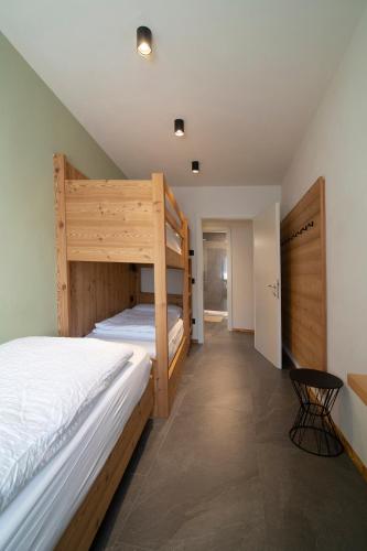 a bedroom with two bunk beds and a table at Casa Montana in Commezzadura