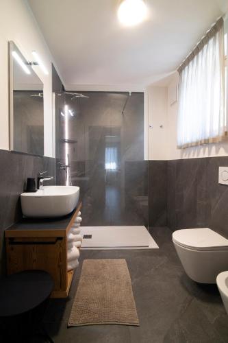 a bathroom with a sink and a toilet at Casa Montana in Commezzadura