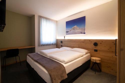 a bedroom with a bed with a picture on the wall at Casa Montana in Commezzadura