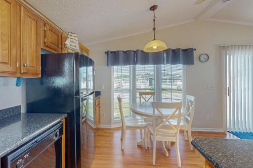 a kitchen with a table and a dining room at Assateague Pointe - Longboat in Berlin