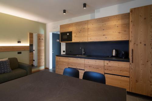 a kitchen with a table and two blue chairs at Casa Montana in Commezzadura