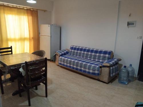 a living room with a couch and a table at Home in ras sedr in Ras Sedr