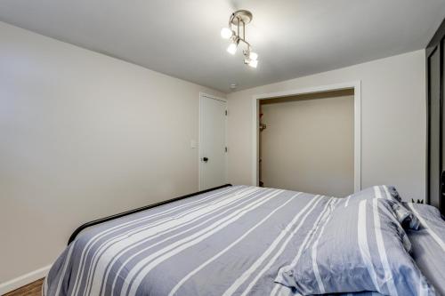 a bedroom with a bed in a white room at Hike, Fish and Explore Lakefront Cottage in Baldwin in Baldwin