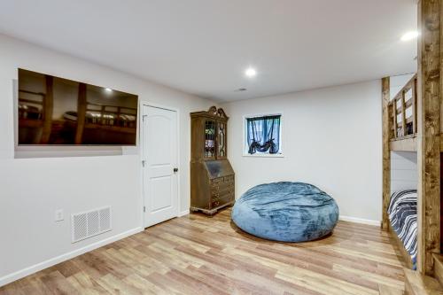 a living room with a large blue ottoman at Hike, Fish and Explore Lakefront Cottage in Baldwin in Baldwin