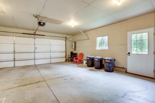an empty garage with three trash cans and a door at Hike, Fish and Explore Lakefront Cottage in Baldwin in Baldwin