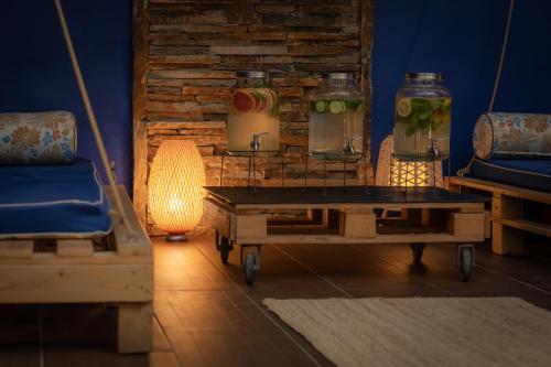 a living room with a table and a brick wall at Snezhanka Hotel Pamporovo-All inclusive & Half Board in Pamporovo