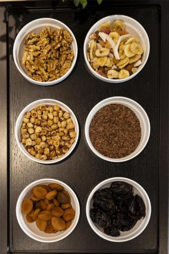 a group of bowls filled with nuts and dried fruits at Best Western Hotel Luxor in Turin