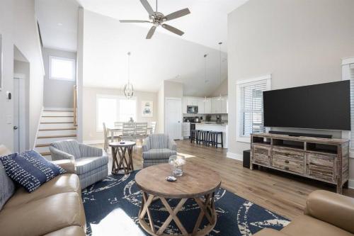a living room with a couch and a tv at Rum-DCA 600 ft to Beach with Hot Tub and Backyard in Nags Head