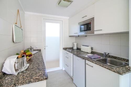 a kitchen with a sink and a counter top at Duvabitat Apartments in Port de Pollensa