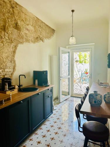 a kitchen with blue cabinets and a table and a window at La Presentosa b&b in Fossacesia