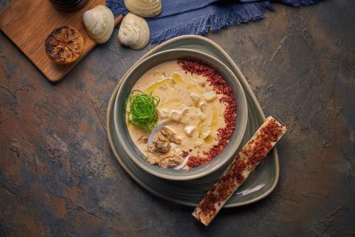 a bowl of soup on a table with a spoon at Holiday Inn Dubai Business Bay by IHG in Dubai