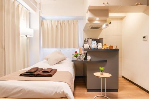 a bedroom with a bed and a table at Sakura Serenity House Komagome in Tokyo