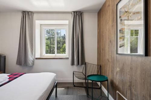 Postel nebo postele na pokoji v ubytování Auberge Manitonga
