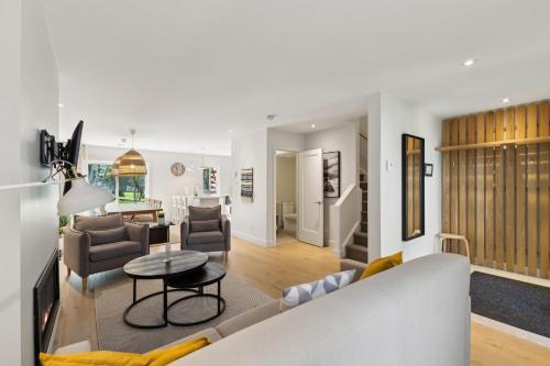 a living room with a couch and a table at Condos Kamik Tremblant by Manitonga in Mont-Tremblant