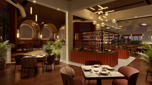 a restaurant with tables and chairs and a bar at Grand Palladium Select Bávaro - All Inclusive in Punta Cana