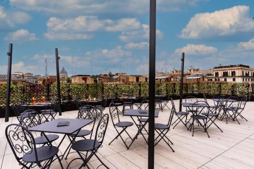 a group of tables and chairs on a patio at Hotel Ottaviano Augusto in Rome