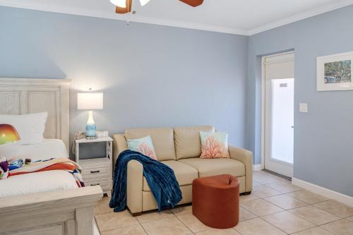 a living room with a couch and a bed at Tropical Beach Resorts - Sarasota in Sarasota