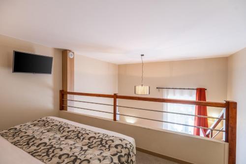 a bedroom with a bed and a window at Aparthotel Adagio Lyon Patio Confluence in Lyon