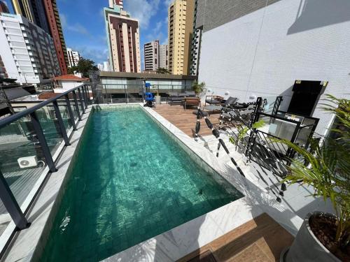 a swimming pool on the roof of a building at Studio306 - Simple 350 in João Pessoa
