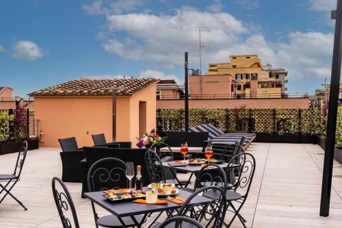 a row of tables and chairs on a patio at Hotel Ottaviano Augusto in Rome