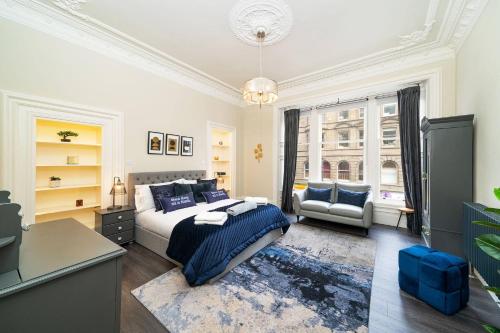 a bedroom with a bed and a desk and a window at Cordis Apartment in Dundee