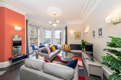 a living room with a couch and a table at Cordis Apartment in Dundee