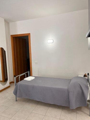 a bedroom with a bed with a light on the wall at Serenity Apartament in Arezzo